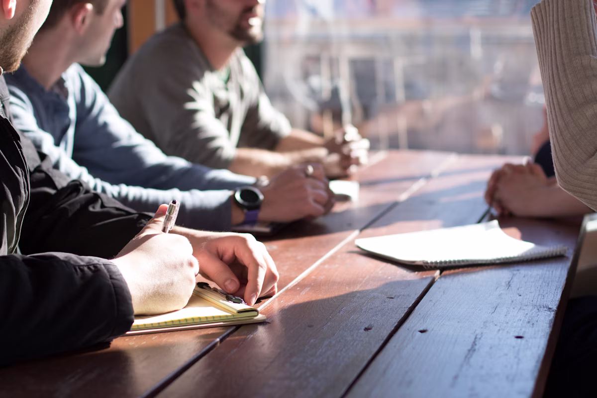 Team gathered in discussion around a table