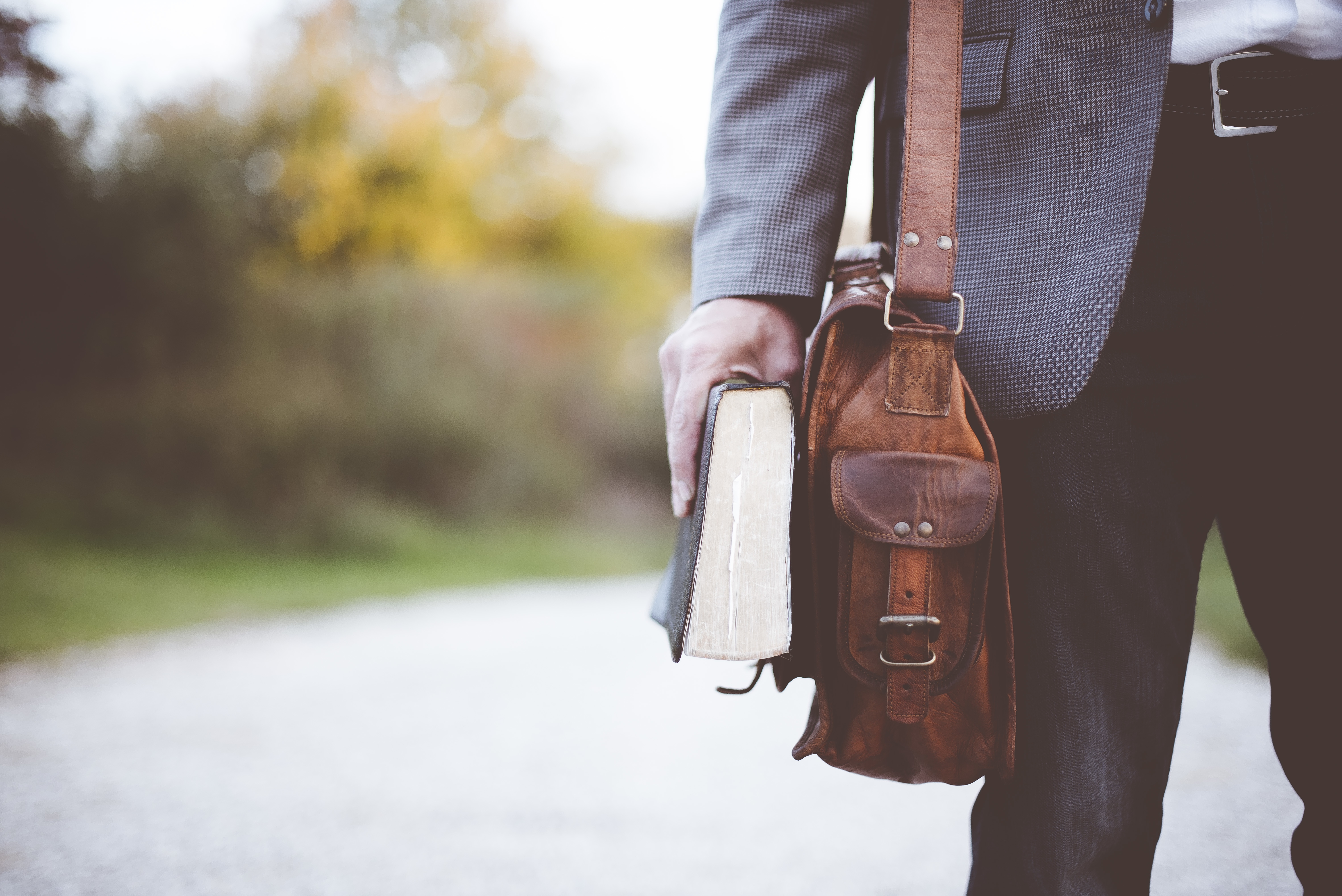 Missionary holding a Bible and shoulder bag
