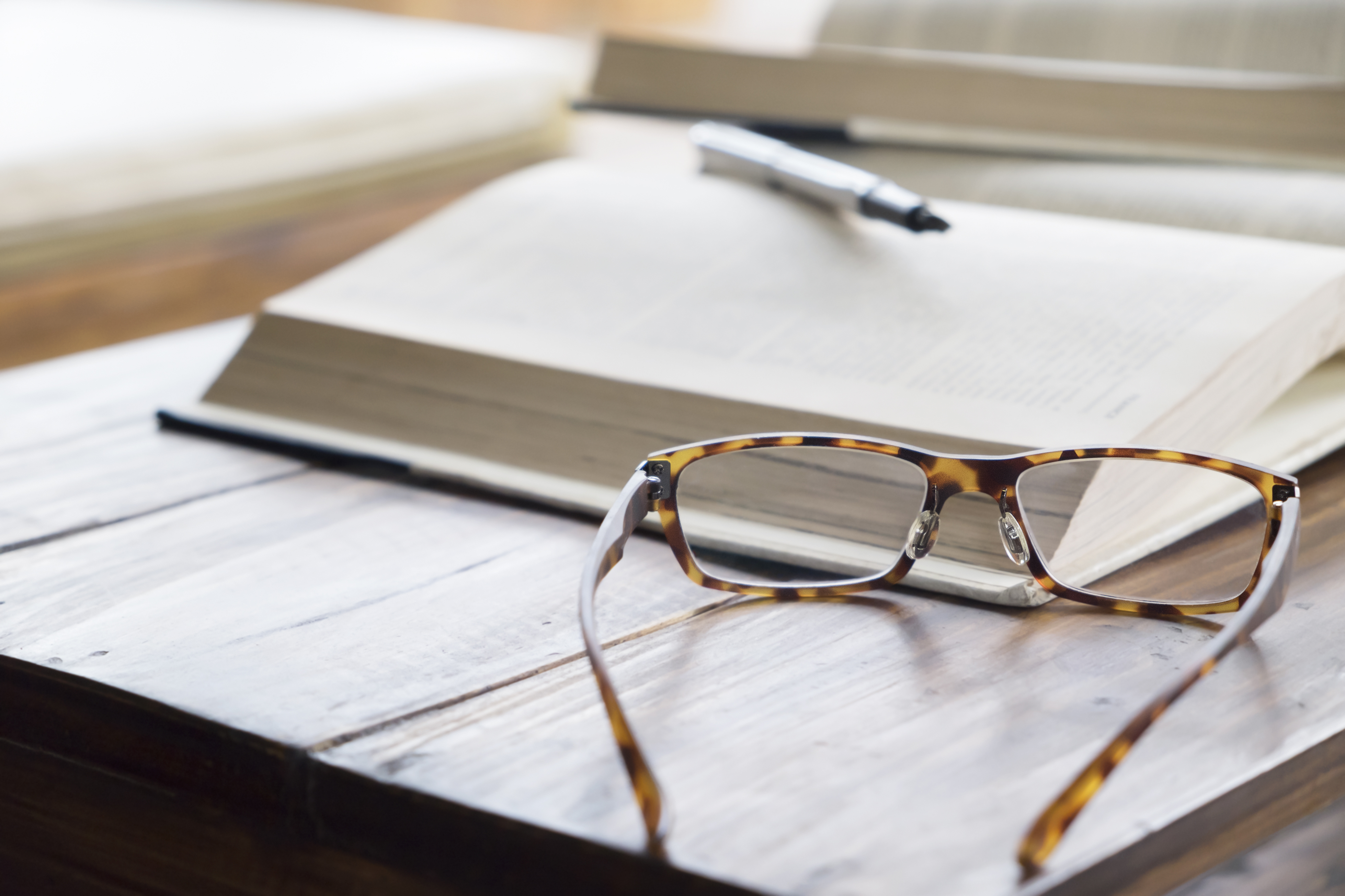 Reading glasses resting on an open book